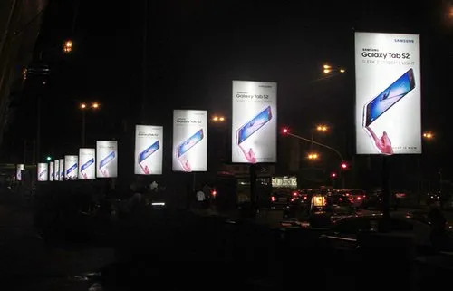 Pole kiosk advertising in Mumbai by ACME Advertising Co., showcasing vibrant street-level branding on high-traffic roads.