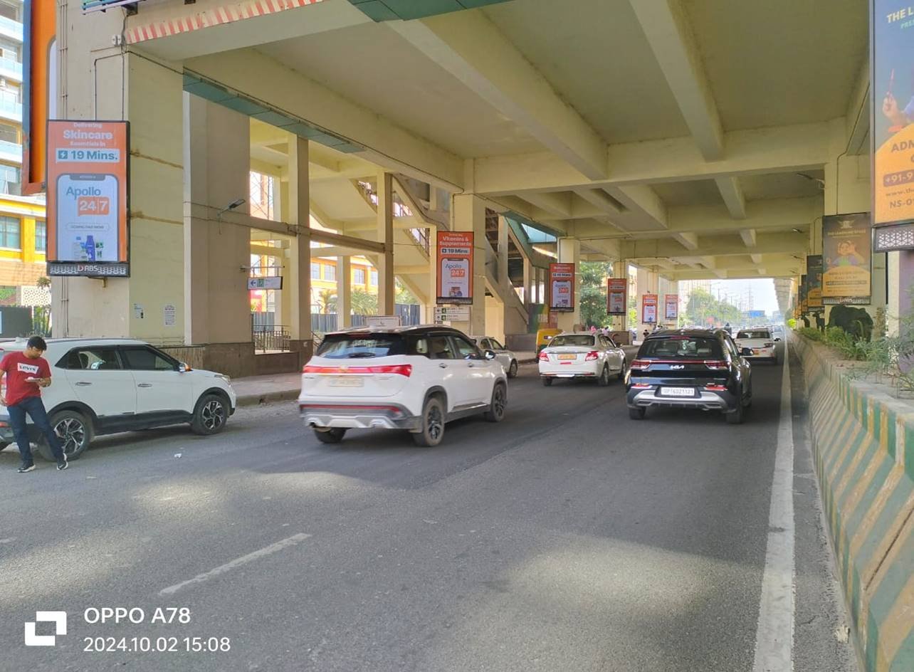 Large outdoor Metro Pillars by Leading unipole advertising companies in Noida offering high-impact visibility with strategic placements across key traffic routes. Advertiser displayed on a busy roadside, showcasing high-impact hoarding advertising for brand visibility in Noida