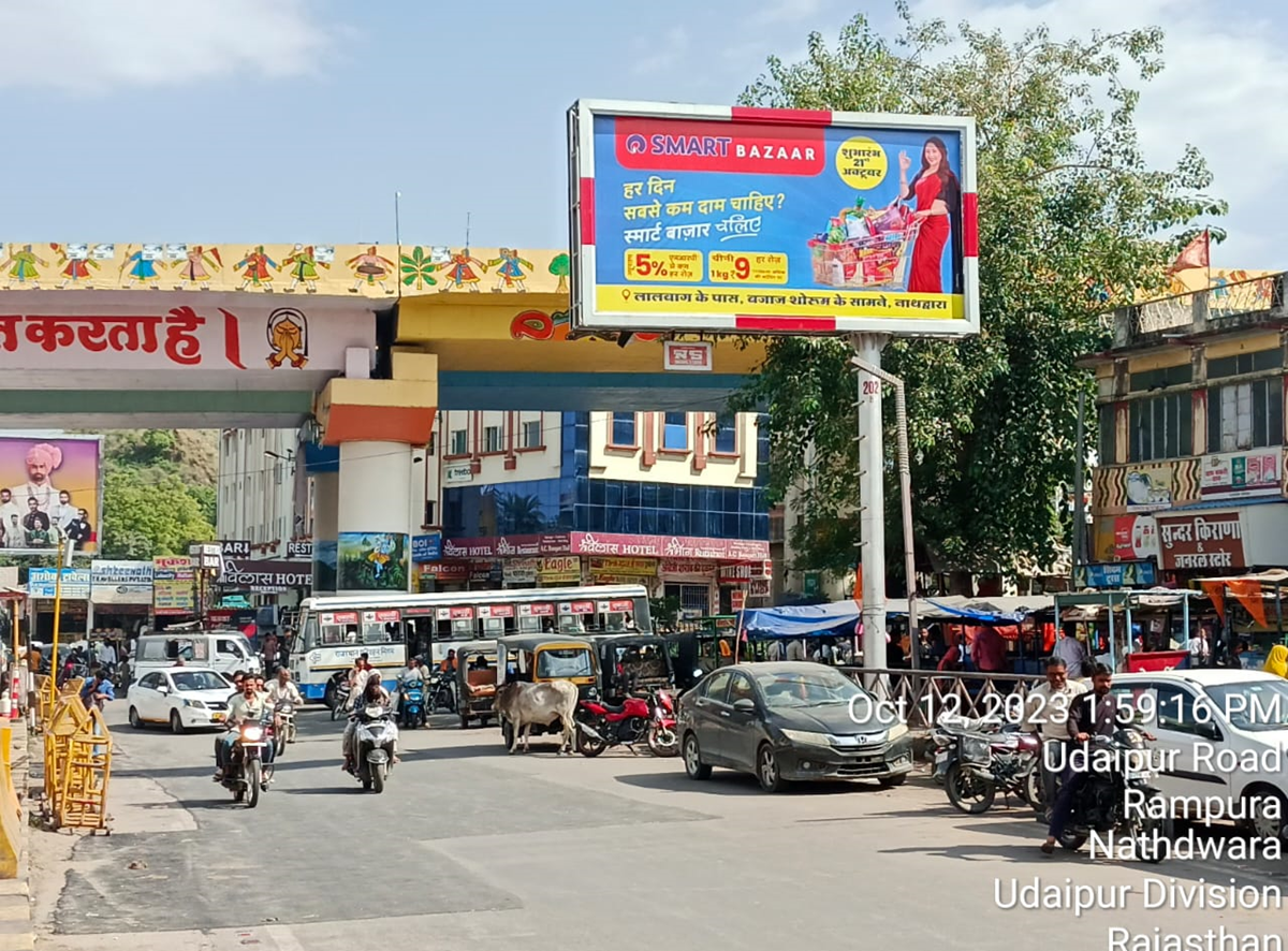 Large roadside billboard in Rajasthan displaying a vibrant brand advertisement, placed in a high-traffic urban area, showcasing the work of leading billboard advertising companies in Rajasthan.