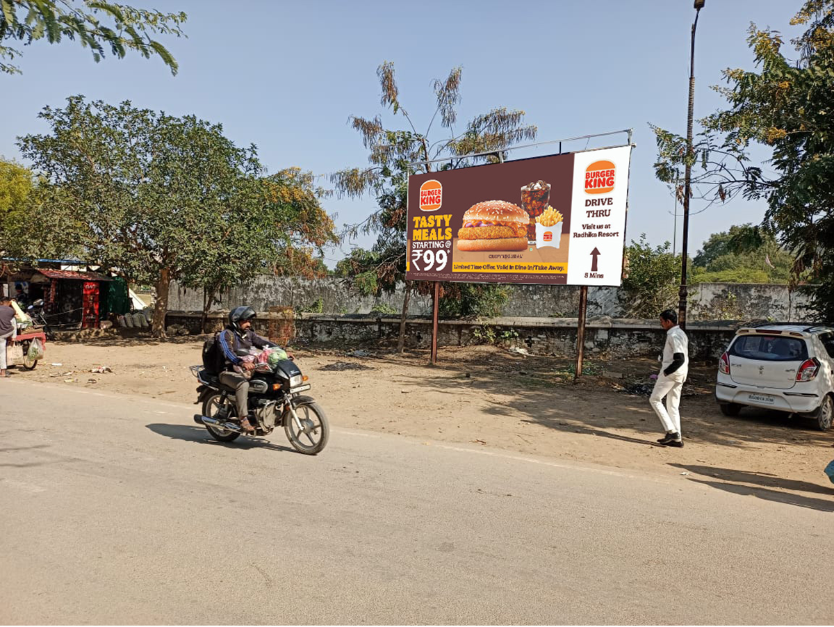 Large roadside billboard in Rajasthan displaying a vibrant brand advertisement, placed in a high-traffic urban area, showcasing the work of leading billboard advertising companies in Rajasthan.